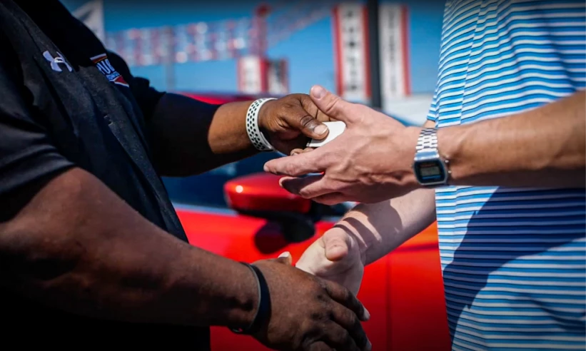 Signifying our mission, a customer receives his new set of auto keys with a handshake.